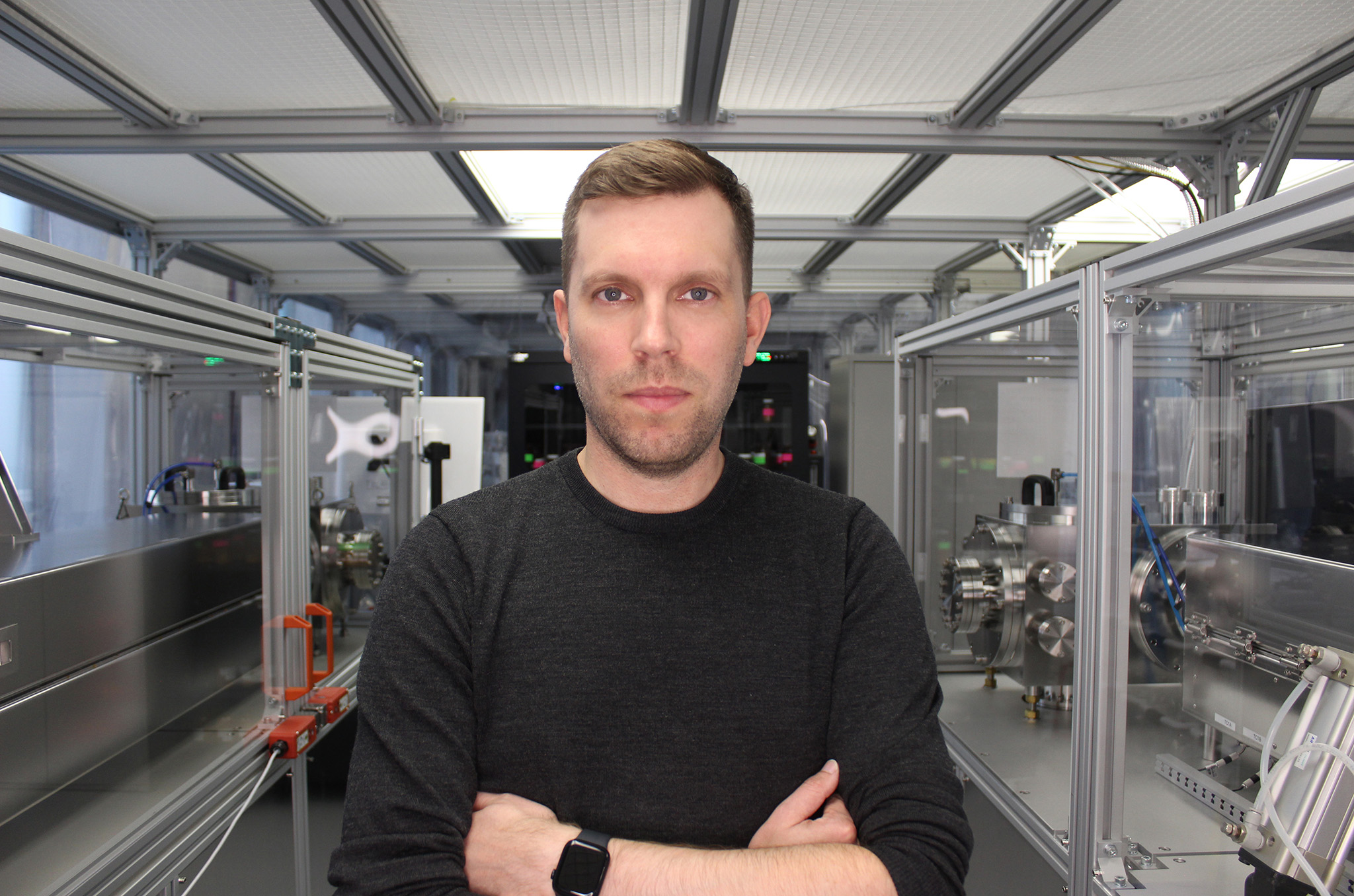 OTI co-founder and CEO Michael G. Helander in front of equipment